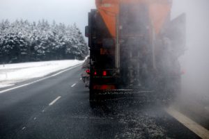 Snow Plow Putting Down De-Icer To Eliminate Black Ice Conditions